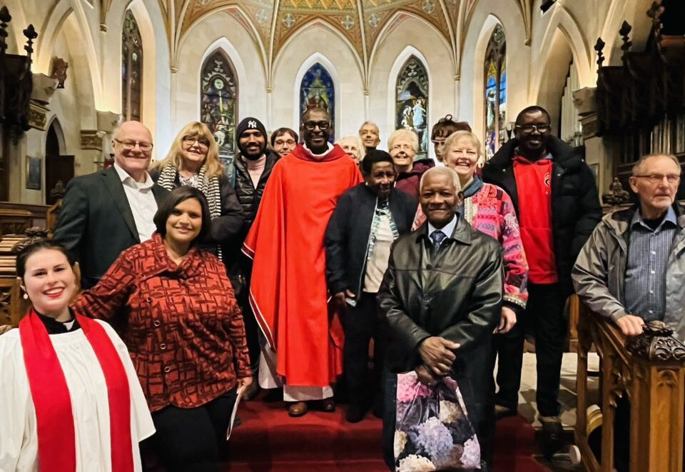 Photo taken on the steps of St Paul's cathedral, London, Ontario. Reverend Gerard is vested in red and surrounded by family and friends