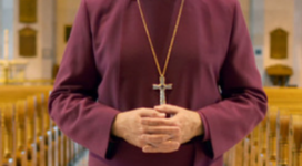 Photo of Bishop Todd Townsend in a cathedral nave wearing purple cassock